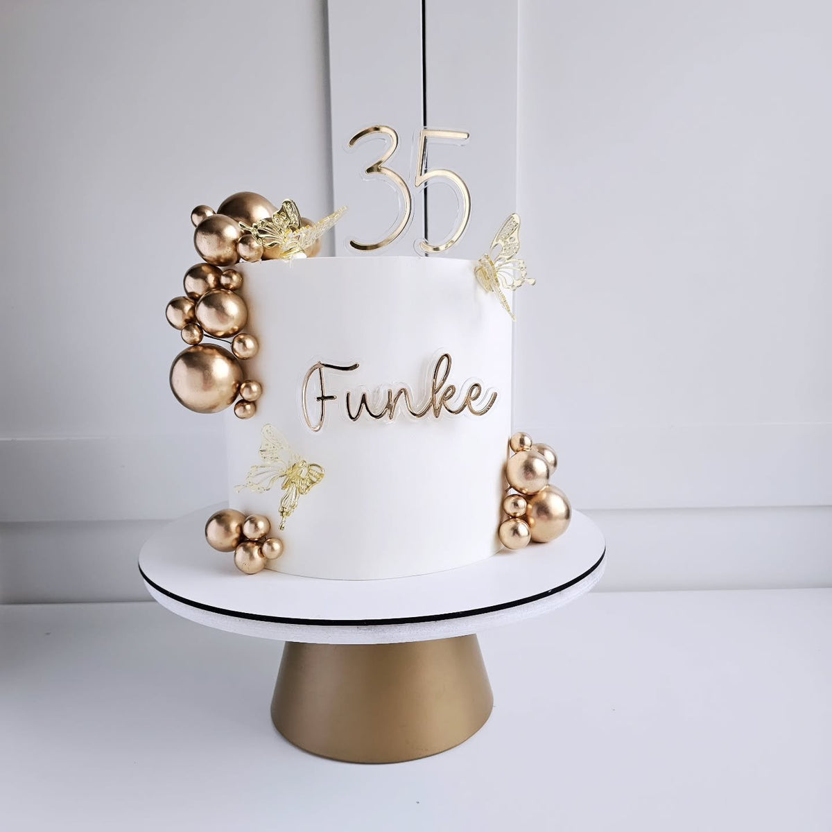 Off-white and gold birthday cake