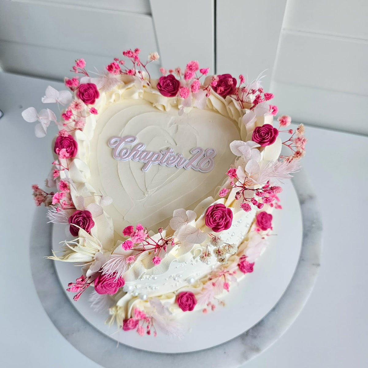 Pink and white floral heart cake