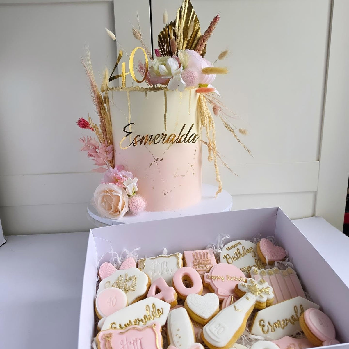 Pink floral cake with a matching biscuit box