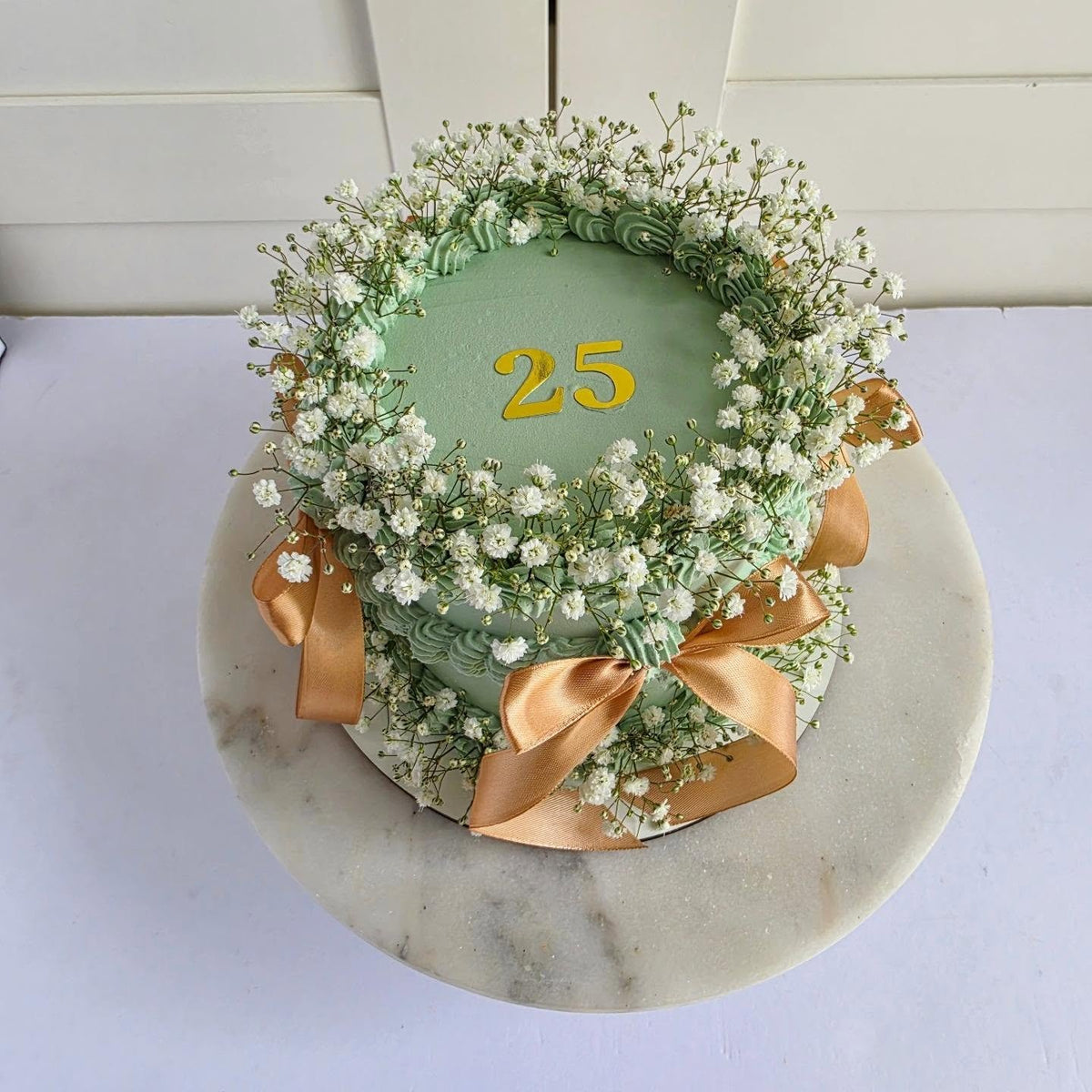 Sage cake with flowers and bows