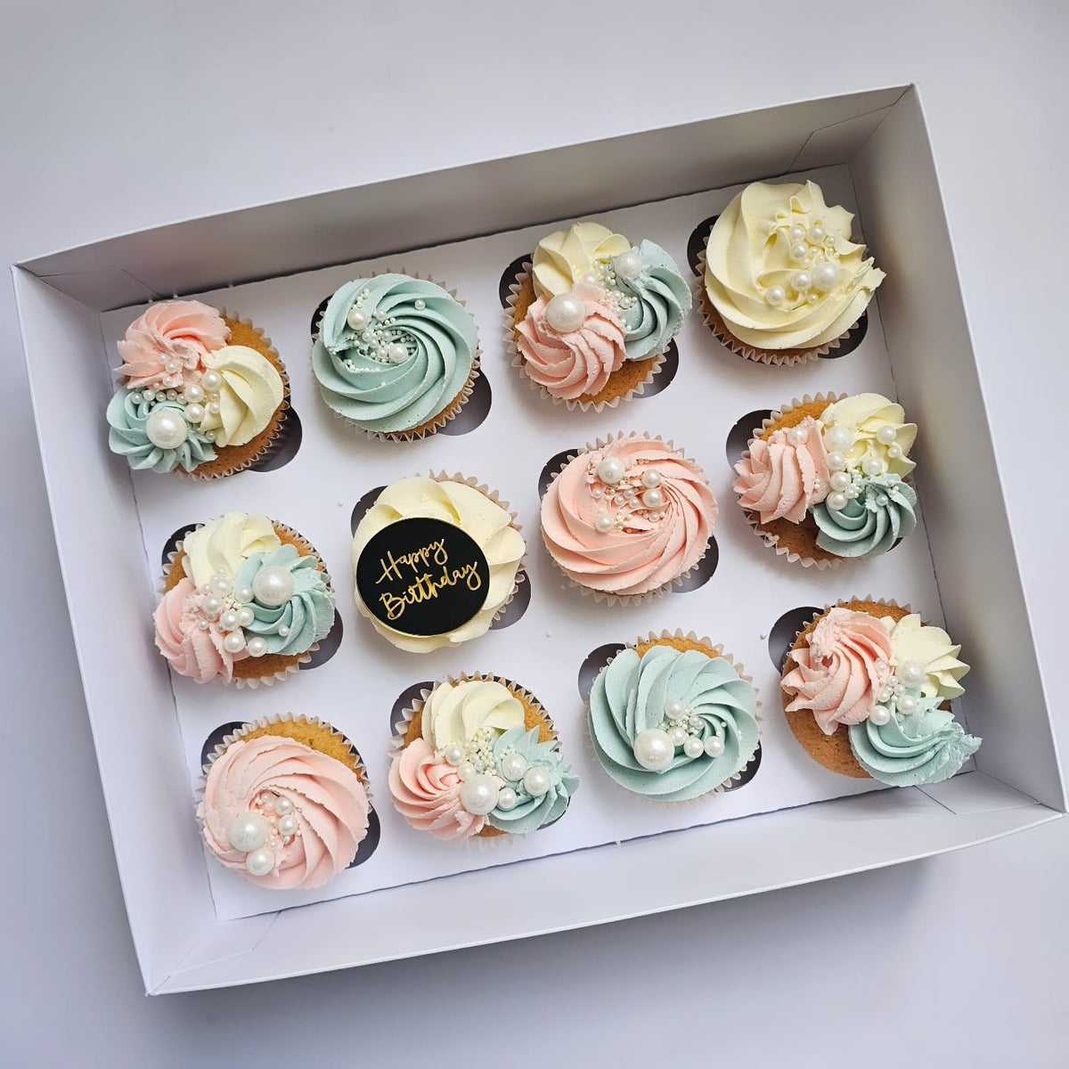 Baby blue and pink birthday cupcakes
