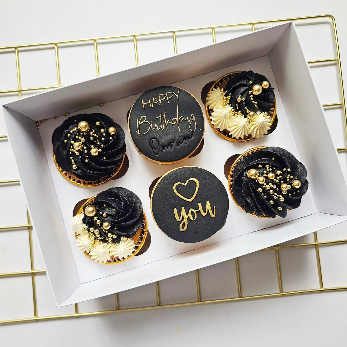 Black, white and gold birthday cupcakes