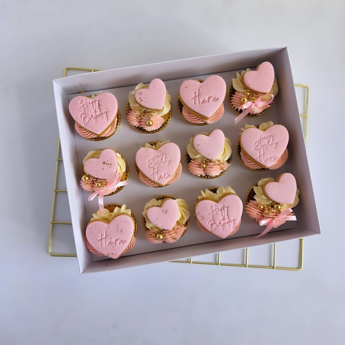 Pink bow cupcakes with biscuit toppers